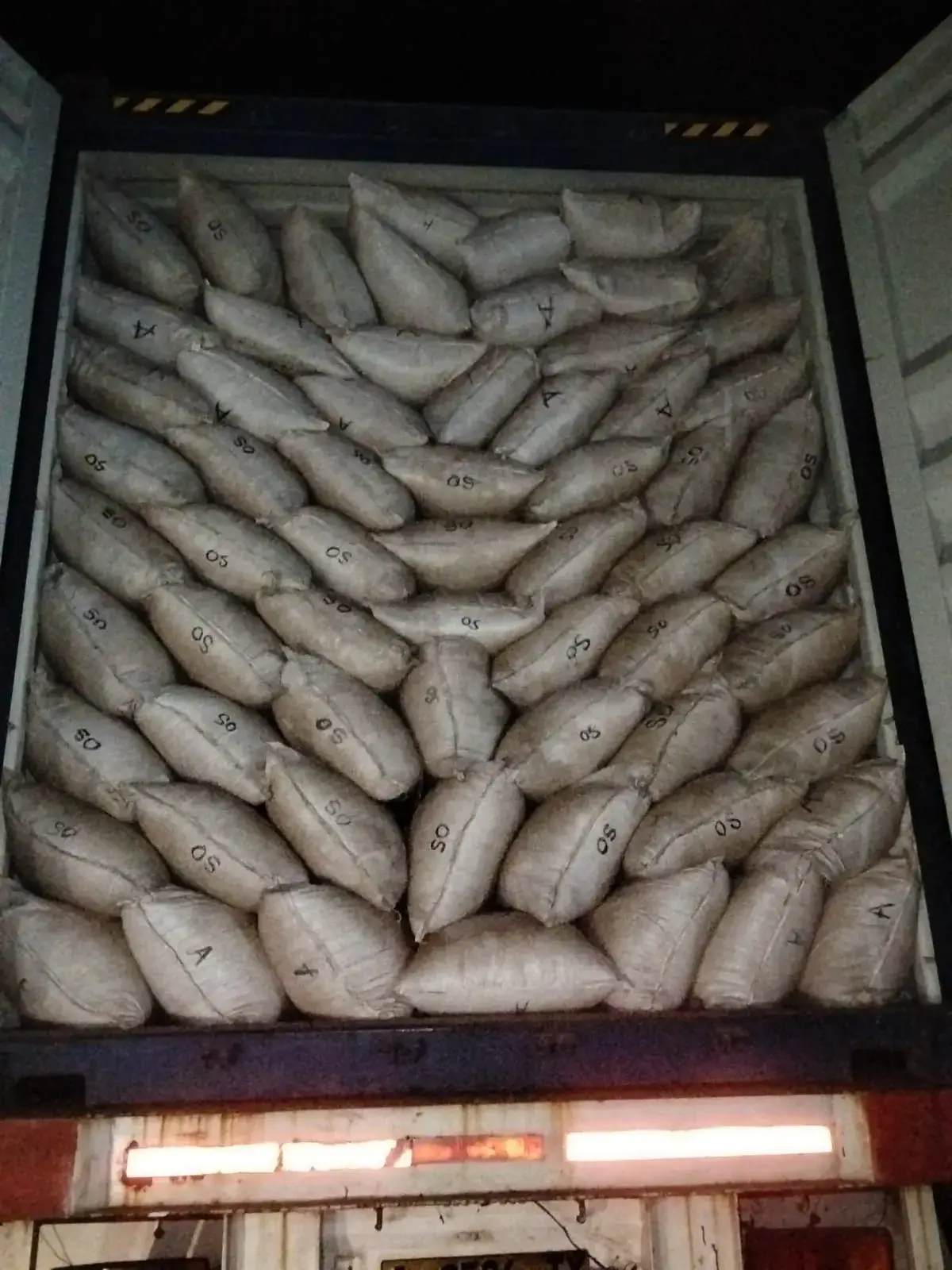 A fully loaded container photographed at night before sealing.