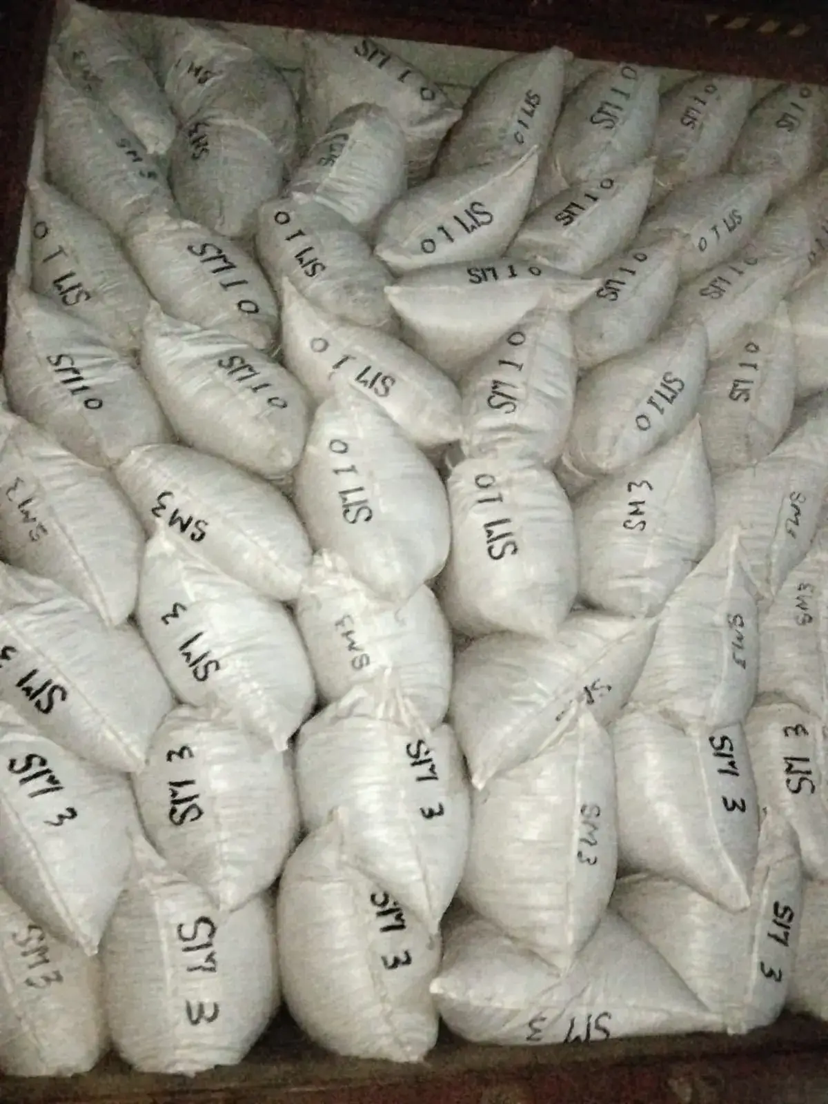 Filled sacks seen from above, marked by grade.