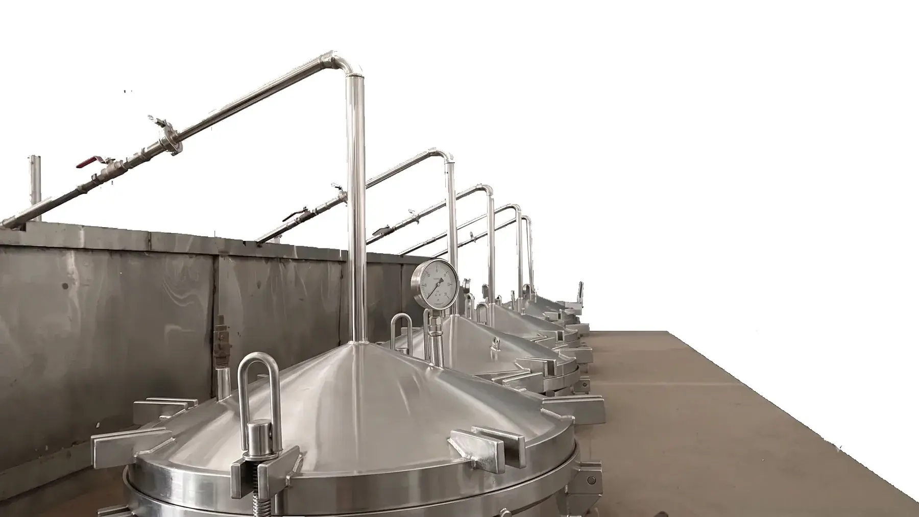A row of stainless steel distillation vessels, cut out of its background.